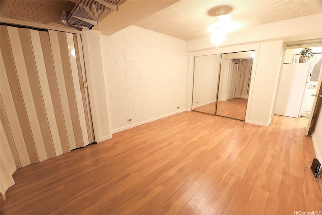 2626 Kuilei St Unit K, Honolulu, HI 96826 - unfurnished bedroom with light wood finished floors and concrete block wall