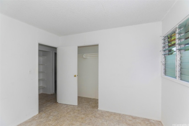 1313 Whitmore Ave, Wahiawa, HI 96786 - unfurnished bedroom featuring a closet and a textured ceiling