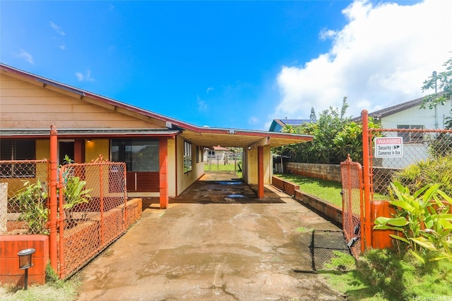 1313 Whitmore Ave, Wahiawa, HI 96786 - view of patio featuring an attached carport and driveway