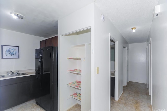 1313 Whitmore Ave, Wahiawa, HI 96786 - kitchen with black fridge with ice dispenser, a sink, and light countertops