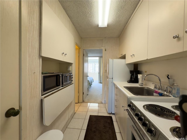 425 Ena Rd Unit 1201B, Honolulu, HI 96815 - kitchen featuring a textured ceiling, a sink, white cabinets, white appliances, and light countertops