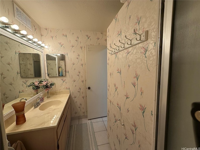425 Ena Rd Unit 1201B, Honolulu, HI 96815 - bathroom with vanity, tile patterned flooring, a textured ceiling, and wallpapered walls