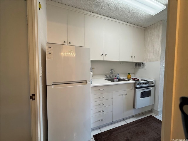 425 Ena Rd Unit 1201B, Honolulu, HI 96815 - kitchen featuring white appliances, a sink, light countertops, light tile patterned floors, and white cabinets