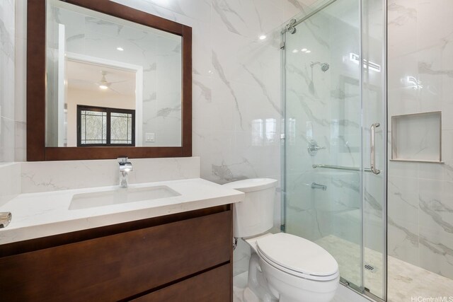 332 Iolani Ave, Honolulu, HI 96813 - bathroom with tile walls, a marble finish shower, toilet, and vanity