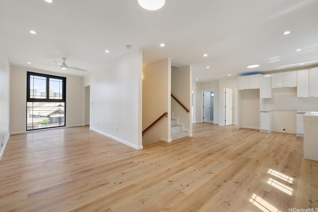332 Iolani Ave, Honolulu, HI 96813 - unfurnished living room with light wood finished floors, recessed lighting, stairway, baseboards, and a ceiling fan