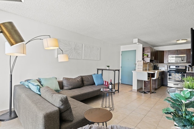 2452 Tusitala St Unit 1101, Honolulu, HI 96815 - living room featuring a textured ceiling and light tile patterned flooring
