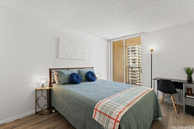 2452 Tusitala St Unit 1101, Honolulu, HI 96815 - bedroom with wood finished floors, baseboards, and a textured ceiling