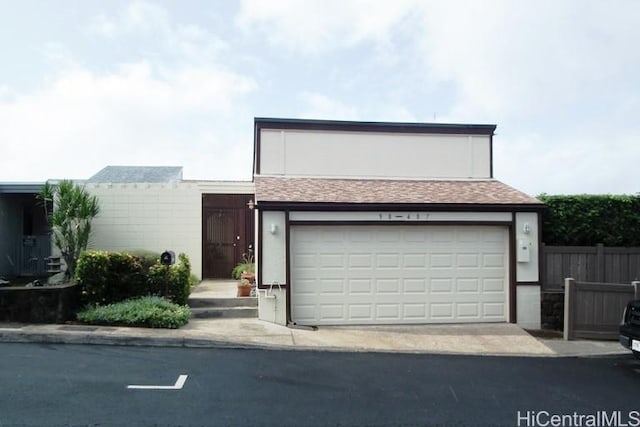 98-487 Kipaepae St Unit 116, Aiea, HI 96701 - view of front of home with fence, a shingled roof, and driveway