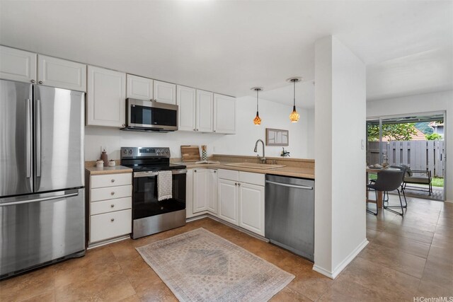 549 Keolu Dr Unit C, Kailua, HI 96734 - kitchen with appliances with stainless steel finishes, a sink, and white cabinetry