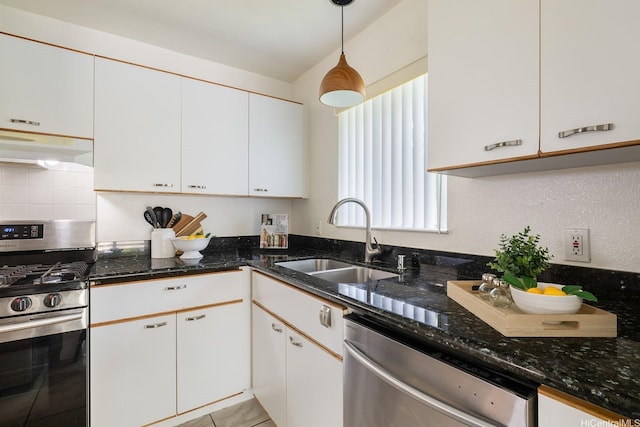 91-1058 Kekuilani Loop Unit 1605, Kapolei, HI 96707 - kitchen with stainless steel appliances, under cabinet range hood, a sink, white cabinetry, and dark stone countertops