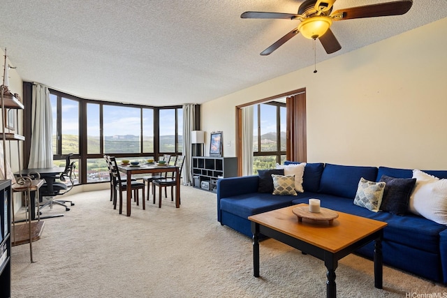 5070 Likini St Unit 1409, Honolulu, HI 96818 - carpeted living area with a textured ceiling, a wall of windows, plenty of natural light, and a ceiling fan