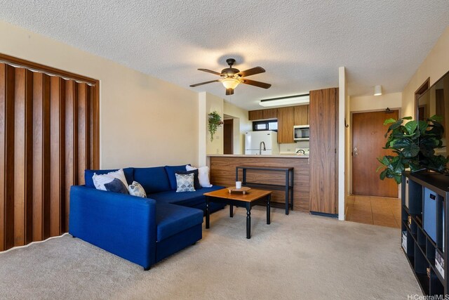 5070 Likini St Unit 1409, Honolulu, HI 96818 - living area with light colored carpet, ceiling fan, and a textured ceiling