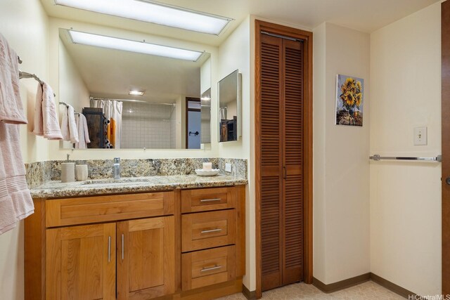 5070 Likini St Unit 1409, Honolulu, HI 96818 - full bathroom featuring a closet, a stall shower, vanity, and baseboards