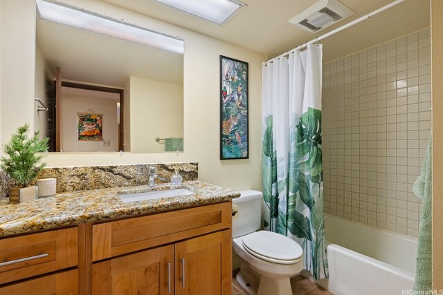 5070 Likini St Unit 1409, Honolulu, HI 96818 - bathroom with toilet, vanity, and shower / bath combo with shower curtain