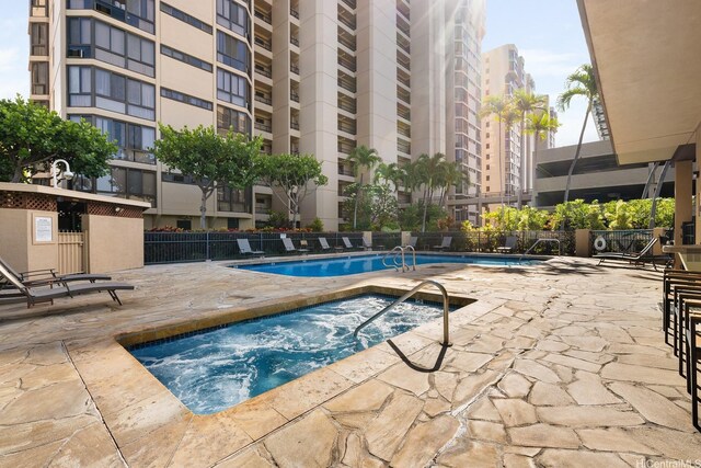 5070 Likini St Unit 1409, Honolulu, HI 96818 - community pool with a community hot tub, a patio, and fence