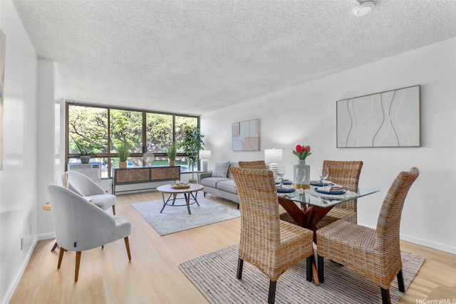 3138 Waialae Ave Unit 521, Honolulu, HI 96816 - dining area with a textured ceiling, light wood-style flooring, cooling unit, and baseboards