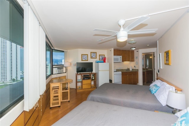 1700 Ala Moana Blvd Unit 1601, Honolulu, HI 96815 - bedroom with light wood-style flooring, freestanding refrigerator, and a sink