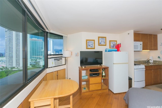 1700 Ala Moana Blvd Unit 1601, Honolulu, HI 96815 - bedroom with freestanding refrigerator, cooling unit, light wood-style flooring, a sink, and a city view