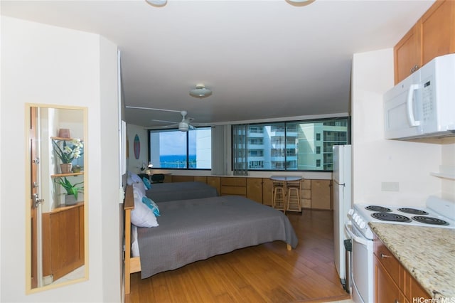 1700 Ala Moana Blvd Unit 1601, Honolulu, HI 96815 - bedroom with light wood-style flooring and freestanding refrigerator