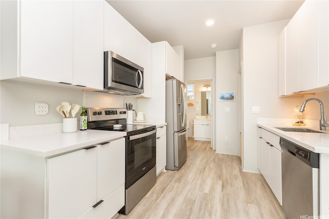 91-3575 Kamolehonua St Unit 1413, Ewa Beach, HI 96706 - kitchen featuring appliances with stainless steel finishes, a sink, white cabinetry, and light wood-style floors