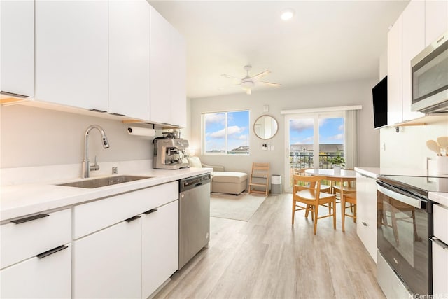 91-3575 Kamolehonua St Unit 1413, Ewa Beach, HI 96706 - kitchen featuring appliances with stainless steel finishes, a sink, light countertops, and light wood-style floors
