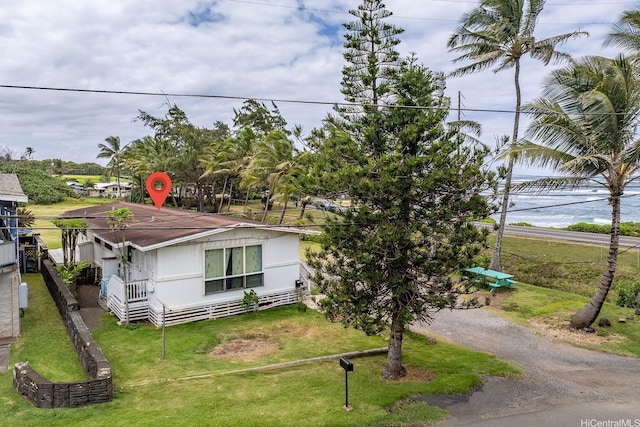 54-011 Waikulama St, Hauula, HI 96717 - view of front of house with dirt driveway and a front lawn
