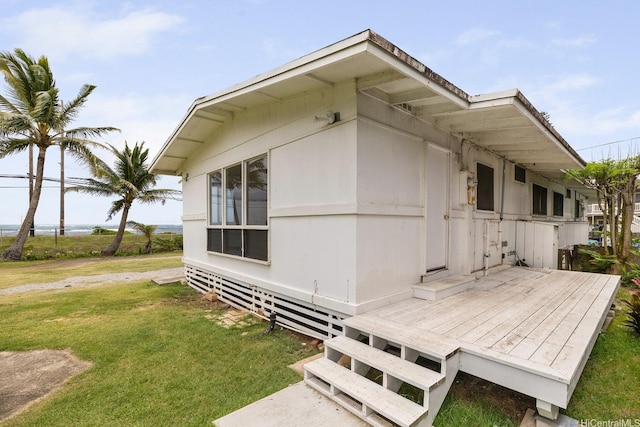 54-011 Waikulama St, Hauula, HI 96717 - view of property exterior with a wooden deck and a yard