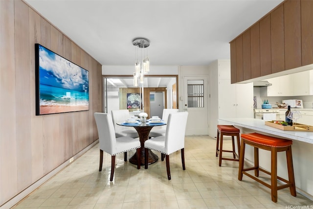 3483 Ala Hinalo St, Honolulu, HI 96818 - dining space featuring wood walls and a chandelier