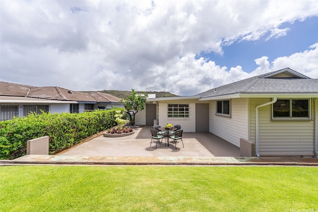 3483 Ala Hinalo St, Honolulu, HI 96818 - back of property featuring a patio, a yard, and a shingled roof