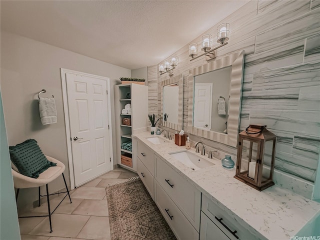 bathroom with vanity, tile patterned floors, and a textured ceiling