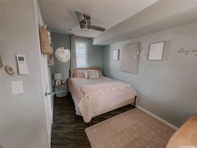 bedroom with baseboards, wood finished floors, and a ceiling fan