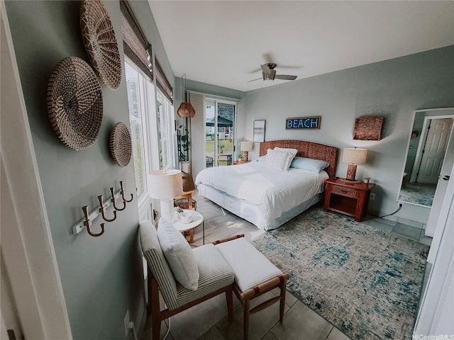 bedroom with access to exterior, tile patterned flooring, and a ceiling fan