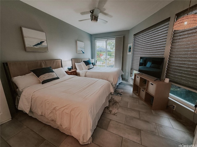 bedroom featuring a ceiling fan and tile patterned floors