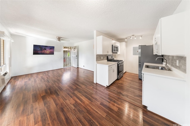 91-1099 Puamaeole St Unit 17U, Ewa Beach, HI 96706 - kitchen featuring gas range, stainless steel microwave, a sink, open floor plan, and a textured ceiling