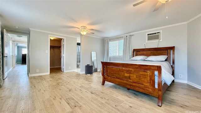 739 Kinalau Pl Unit 1, Honolulu, HI 96813 - bedroom with ornamental molding, an AC wall unit, light wood finished floors, baseboards, and a spacious closet