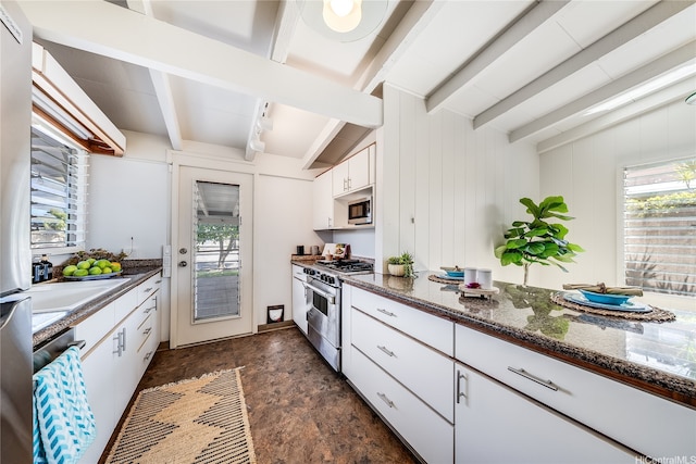 520 Papalani St, Kailua, HI 96734 - kitchen with stainless steel appliances, white cabinets, dark stone finish flooring, and dark stone counters