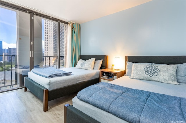 1850 Ala Moana Blvd Unit 603, Honolulu, HI 96815 - bedroom featuring wood finished floors, a view of city, multiple windows, and expansive windows