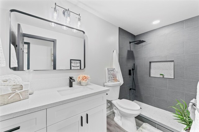87-888 Waapuhi St, Waianae, HI 96792 - full bathroom with toilet, a tile shower, vanity, and wood finished floors