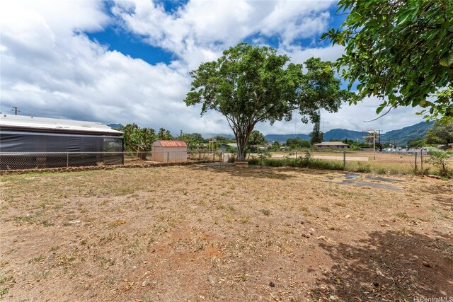 87-888 Waapuhi St, Waianae, HI 96792 - view of yard with fence, a mountain view, and an outdoor structure