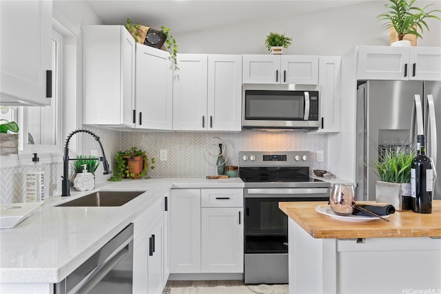 87-888 Waapuhi St, Waianae, HI 96792 - kitchen with stainless steel appliances, a sink, wood counters, and decorative backsplash