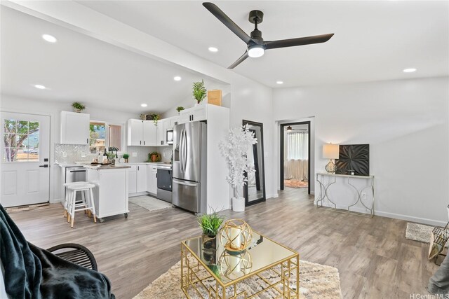 87-888 Waapuhi St, Waianae, HI 96792 - living area featuring ceiling fan, vaulted ceiling, recessed lighting, and light wood-style floors