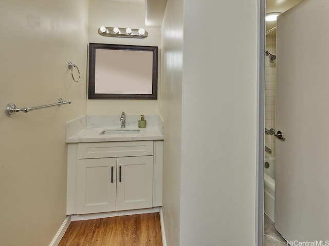 1333 Heulu St Unit 408, Honolulu, HI 96822 - bathroom with vanity, wood finished floors, tub / shower combination, and baseboards