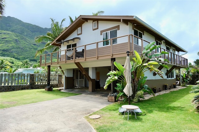 51-416 Kamehameha Hwy Unit A, Kaaawa, HI 96730 - view of front of house with stucco siding, a front lawn, a carport, and a deck with mountain view