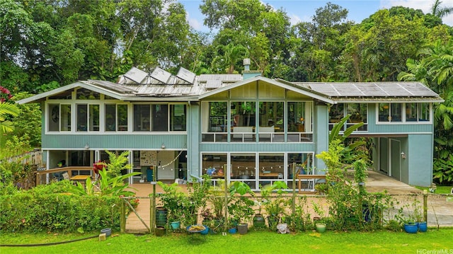 1149 Maunawili Rd, Kailua, HI 96734 - back of house featuring a sunroom, concrete driveway, and metal roof