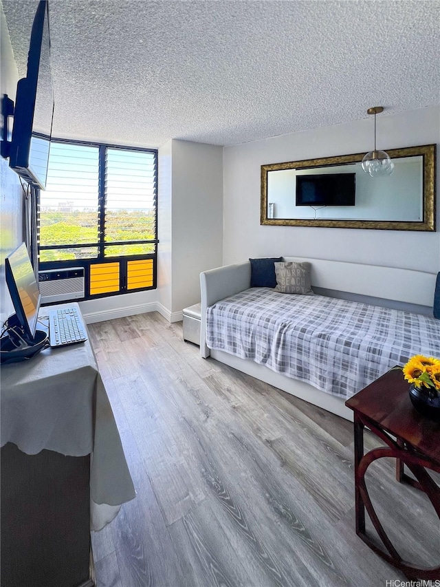 134 Kapahulu Ave Unit 707, Honolulu, HI 96815 - bedroom featuring wood finished floors, a textured ceiling, and baseboards