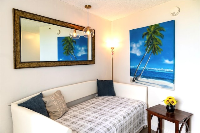 134 Kapahulu Ave Unit 707, Honolulu, HI 96815 - bedroom featuring a textured ceiling and a water view