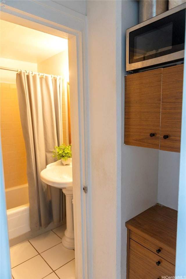 134 Kapahulu Ave Unit 707, Honolulu, HI 96815 - bathroom with shower / tub combo with curtain and tile patterned floors
