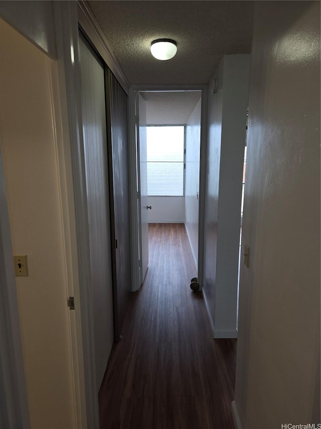 910 Kapahulu Ave Unit 303, Honolulu, HI 96816 - corridor featuring dark wood-style flooring, a textured ceiling, and baseboards