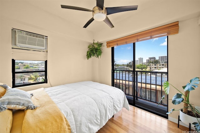 738 Palani Ave Unit 401, Honolulu, HI 96816 - bedroom with a wall mounted air conditioner, access to outside, multiple windows, and wood finished floors