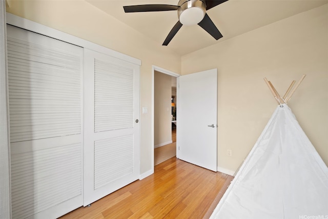 738 Palani Ave Unit 401, Honolulu, HI 96816 - unfurnished bedroom with light wood finished floors, a closet, a ceiling fan, and baseboards